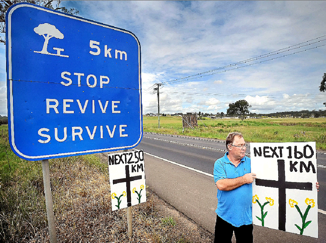 Former paramedic Wade Walker places some makeshift signs on the Pacific Highway south of Grafton warning of the danger of the single carriageway section of highway. Former paramedic Wade Walker places some makeshift signs on the Pacific Highway south of Grafton warning of the danger of the single carriageway section of highway.