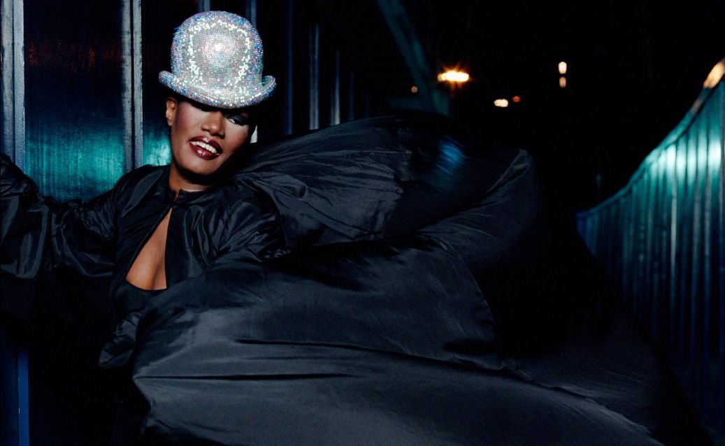 A black curtain dropped to reveal Jones standing at the top of an elevated platform in a metre-high feather headpiece and singing the opening lyrics to her 1981 hit Nightclubbing. A black curtain dropped to reveal Jones standing at the top of an elevated platform in a metre-high feather headpiece and singing the opening lyrics to her 1981 hit Nightclubbing.
