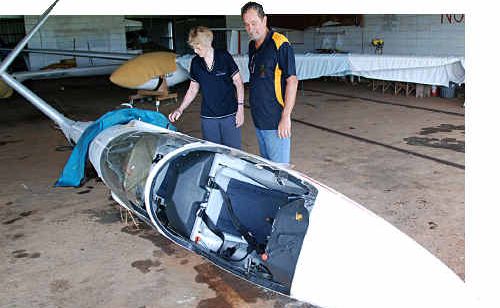 Gympie Gliding Club secretary Judith Smith and club member David Rees look over the crippled aircraft after a crash at Kybong Airport on Sunday. Gympie Gliding Club secretary Judith Smith and club member David Rees look over the crippled aircraft after a crash at Kybong Airport on Sunday.