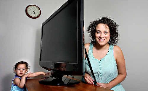 Pamela Rose-Holt puts an anti-tip strap on her TV to protect 13-month-old Gemma Lee Rose Holt from possible injury. Pamela Rose-Holt puts an anti-tip strap on her TV to protect 13-month-old Gemma Lee Rose Holt from possible injury.