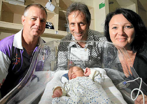 Banora Point firefighter Andrew Stalker presents a donation to Dr David McMaster and Sandra Meskell from The Tweed Hospital’s neonatal ward. Photo: Blainey Woodham
