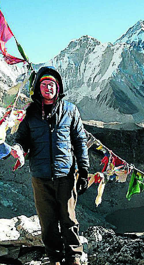 Tim Hentschel suitably rugged up at Kala Patar, which at an altitude of 5800 metres is the best view point for Mount Everest, towering in the background.