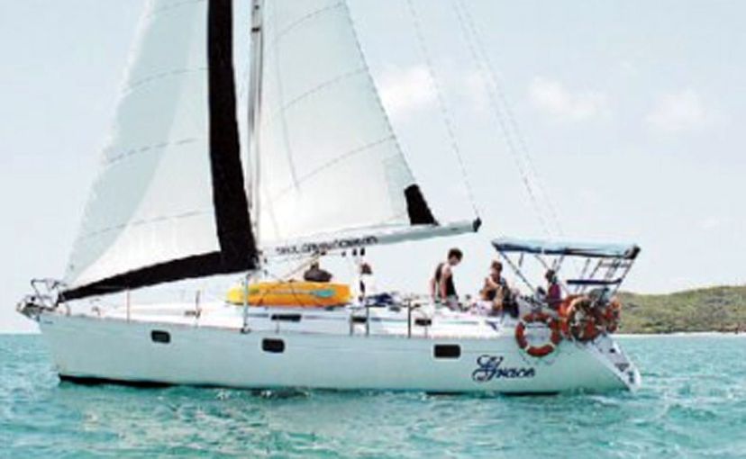 The sailboat Grace glides across the clear blue water off the Capricorn Coast. The sailboat Grace glides across the clear blue water off the Capricorn Coast.
