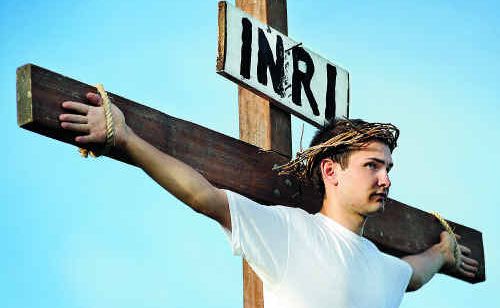 Caleb Salagaras on the cross delivering the Easter message at the Hervey Bay Baptist Church. Caleb Salagaras on the cross delivering the Easter message at the Hervey Bay Baptist Church.