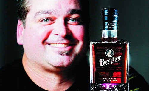 Jason Pearson with a bottle of aged Bundaberg Rum signed by the distillers which he bid for in an online auction and paid nearly $8000 for. The money was donated to Bundaberg SES. Jason Pearson with a bottle of aged Bundaberg Rum signed by the distillers which he bid for in an online auction and paid nearly $8000 for. The money was donated to Bundaberg SES.