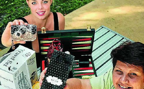 Maxine Brushe, right, and Lea Lobel display the massive Mother’s Day hamper being raffled off at Beach Arts Music (BAM) on Saturday.