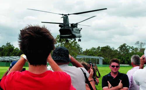 A Chinook helicopter takes off after delivering much-needed food and medical supplies to Mt Crosby State School emergency centre during the floods disaster. A Chinook helicopter takes off after delivering much-needed food and medical supplies to Mt Crosby State School emergency centre during the floods disaster.