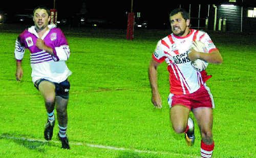 Killarney Cutters player Michael Marshall runs with the ball at Charlie Andrews Oval Friday night. Killarney Cutters player Michael Marshall runs with the ball at Charlie Andrews Oval Friday night.