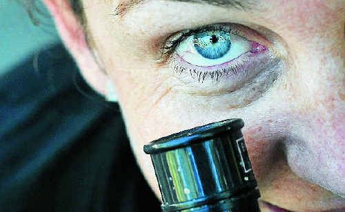 Kate Larson from the Boyne Island Environment Centre tests the telescope in preparation to view the alignment of planets.