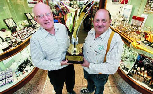David Peel and Peter Peirano hold up the Rocky Amateur Cup in Phil Peel Leading Edge Jeweller on East St where it is currently on display. David Peel and Peter Peirano hold up the Rocky Amateur Cup in Phil Peel Leading Edge Jeweller on East St where it is currently on display.