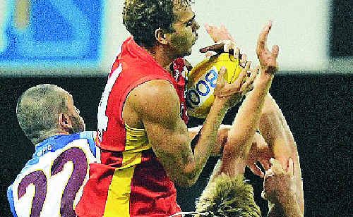 Gold Coast Suns player Nathan Krakouer (centre) takes a high mark against the Brisbane Lions on Saturday. Gold Coast Suns player Nathan Krakouer (centre) takes a high mark against the Brisbane Lions on Saturday.