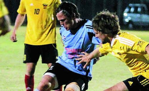 Bundaberg Spirit’s Korey Nix, left, keeps his Fire opponent at bay as he considers his options. Bundaberg Spirit’s Korey Nix, left, keeps his Fire opponent at bay as he considers his options.