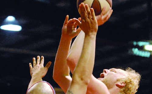 Meteors player Michael Kingma makes a shot over Rockhampton import Travis Reed