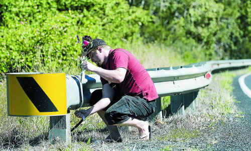 Casino resident Ashley Rankin places flowers for Kyla Rogers near the site at Piora where the bodies of the girl and her father were found. Inset: Five-year-old Kyla. Casino resident Ashley Rankin places flowers for Kyla Rogers near the site at Piora where the bodies of the girl and her father were found. Inset: Five-year-old Kyla.