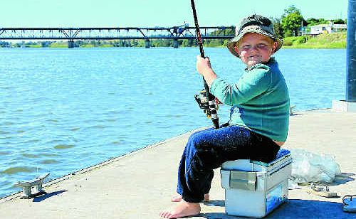 Joshua Hunter, 5, of Grafton was happy sitting on his tackle box while waiting for a fish to bite at the South Grafton pier on Saturday. Joshua Hunter, 5, of Grafton was happy sitting on his tackle box while waiting for a fish to bite at the South Grafton pier on Saturday.