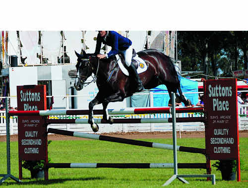 Clem Smith takes Florina over the first of the treble combination jumps in the final round of the Grand Prix at the Gympie Show. Clem Smith takes Florina over the first of the treble combination jumps in the final round of the Grand Prix at the Gympie Show.