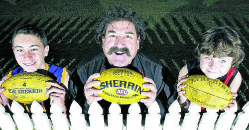 Ballina Bombers junior footballers, Jack Oates (left), 13, and Lochie Cottrill, 8, with AFL legend Robert “Dipper” DiPierdomenico at Ballina yesterday. Ballina Bombers junior footballers, Jack Oates (left), 13, and Lochie Cottrill, 8, with AFL legend Robert “Dipper” DiPierdomenico at Ballina yesterday.