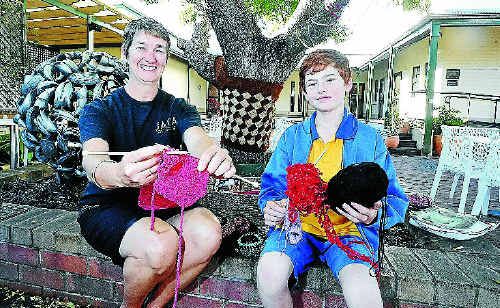 Annie Hackett, of Georgie’s Cafe, and 10-year-old Samuel Page with some of the knit-wear for the Clarence Valley guerrilla knitting project. Photo: JOJO NEWBY Annie Hackett, of Georgie’s Cafe, and 10-year-old Samuel Page with some of the knit-wear for the Clarence Valley guerrilla knitting project. Photo: JOJO NEWBY