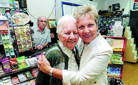 Margaret Byrnes, of Goonellabah, gets a hug from her daughter, Gwenda Byrnes, after winning a holiday in the Nextra Mothers’ Day competition. Lismore newsagent Royce Jenkins looks on. 