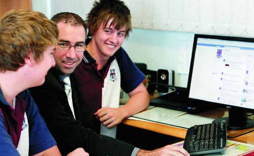 Mackay State High School student Steven Ruhle, deputy principal Cameron Wayman and student Lachlan Forsyth look at the school’s new Facebook page.. Mackay State High School student Steven Ruhle, deputy principal Cameron Wayman and student Lachlan Forsyth look at the school’s new Facebook page..