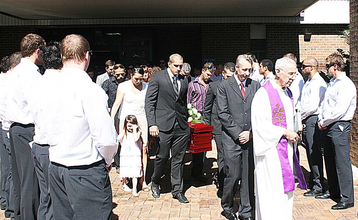 HONOURING A CHAMPION: The North Queenslans Cowboys line in a guard of honour as Sam Faust's coffin is taken to the hearse by his close family and friends. HONOURING A CHAMPION: The North Queenslans Cowboys line in a guard of honour as Sam Faust's coffin is taken to the hearse by his close family and friends.