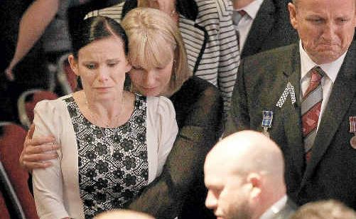 Inside the Gold Coast Convention Centre Sonya Leeding is comforted as the casket passes. Inside the Gold Coast Convention Centre Sonya Leeding is comforted as the casket passes.