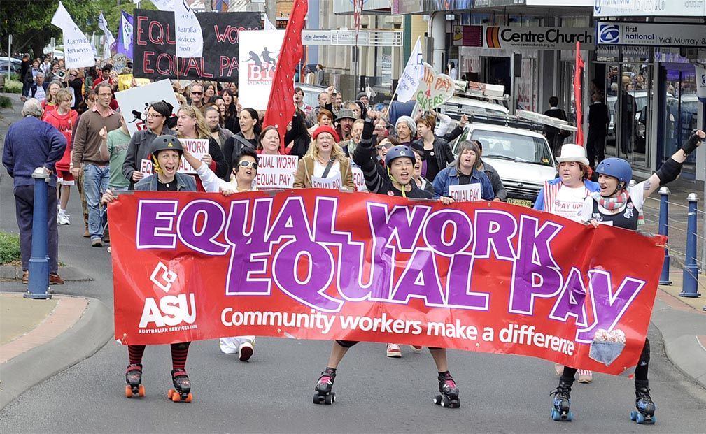Protesters march through Lismore's CBD rallying for equal pay for community workers.