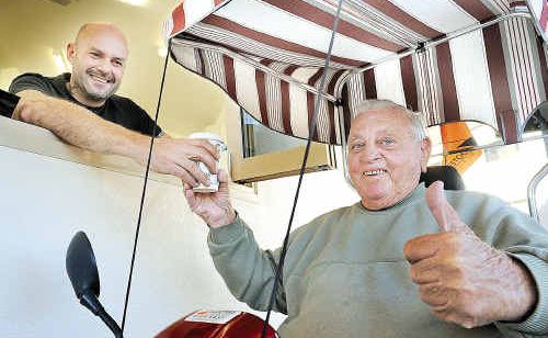 Vince Rovere serves Dennis Coulson at the grand opening of the Hervey Bay Toast Espresso Bar - the shop has a drive-in window for mobility scooters. Vince Rovere serves Dennis Coulson at the grand opening of the Hervey Bay Toast Espresso Bar - the shop has a drive-in window for mobility scooters.