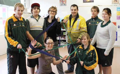 The QAC with students in a workshop demonstrating with elastic electricity connectedness. The QAC with students in a workshop demonstrating with elastic electricity connectedness.