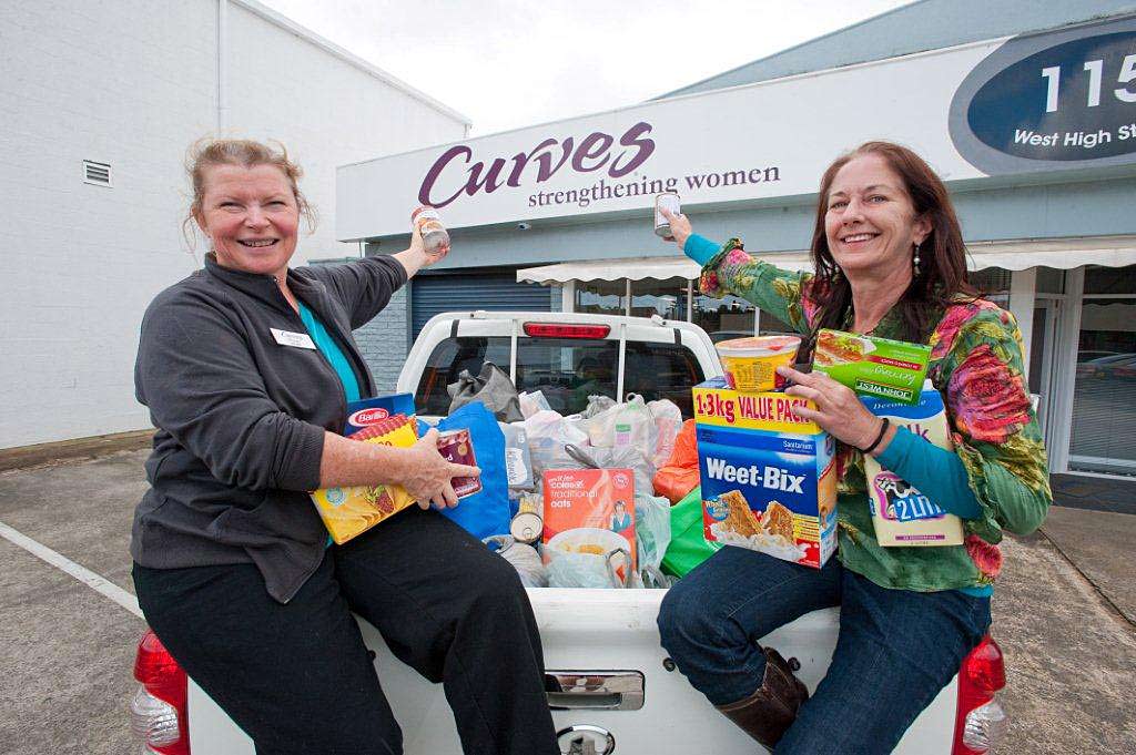 Margo McKillop from Curves gives Charlotte Young from the Warrina Women and Children’s Refuge more than 500kg of food and other goods.


