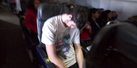 Furious passengers took photos of Mr Aitken sleeping it off. Furious passengers took photos of Mr Aitken sleeping it off.