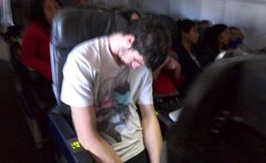 Furious passengers took photos of Mr Aitken sleeping it off. Furious passengers took photos of Mr Aitken sleeping it off.