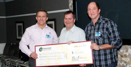 Broncos CEO Paul White, Sports Minister Phil Reeves and rugby league development officer Darren Burns with a cheque for $156,000 which will keep Burns in the district for the next three years. Broncos CEO Paul White, Sports Minister Phil Reeves and rugby league development officer Darren Burns with a cheque for $156,000 which will keep Burns in the district for the next three years.