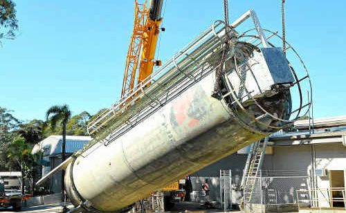 The old cement silo comes down to make way for a new vehicle storage facility in Toormina. 