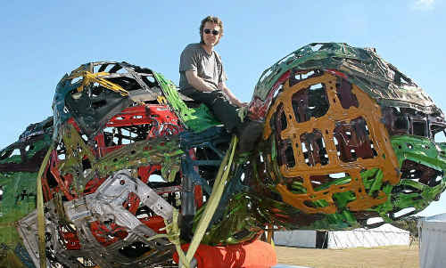 Daniel Clemmett 'rides' his massive sculpture the Venus of Wilendorf onto the Byron Bay Writers' Festival site on Tuesday. Daniel Clemmett 'rides' his massive sculpture the Venus of Wilendorf onto the Byron Bay Writers' Festival site on Tuesday.