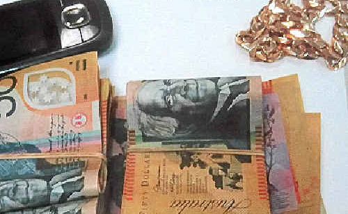 CASH, phone and jewellery seized during a search of a car at Clothiers Creek yesterday. CASH, phone and jewellery seized during a search of a car at Clothiers Creek yesterday.