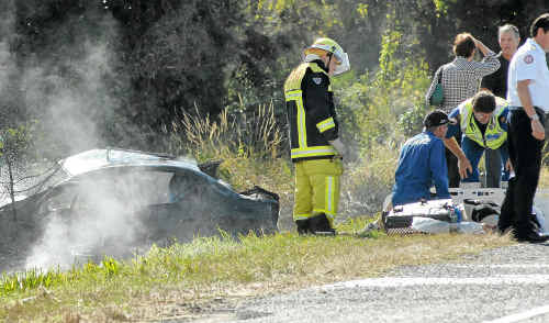 Firefighters extinguish flames following the fatal crash on Saturday. Firefighters extinguish flames following the fatal crash on Saturday.