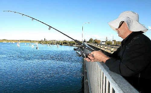 Avid fishers continue to fish from Boyds Bay Bridge despite clear prohibition signage.