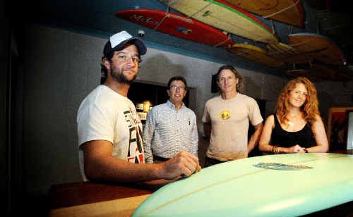 Pictured with a Michael Peterson surfboard to raise money for Aussies for Orphans, are from left, co-owner of Woodys Surf Shack in Byron Loren Nowland, Steve Lewis from Aussies for Orphans, surfboard shaper Simon Jones and co-owner of Woodys Caitlin Leiweke . Pictured with a Michael Peterson surfboard to raise money for Aussies for Orphans, are from left, co-owner of Woodys Surf Shack in Byron Loren Nowland, Steve Lewis from Aussies for Orphans, surfboard shaper Simon Jones and co-owner of Woodys Caitlin Leiweke .