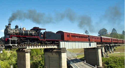 The historic Valley Rattler snakes its way over a railway bridge. The historic Valley Rattler snakes its way over a railway bridge.