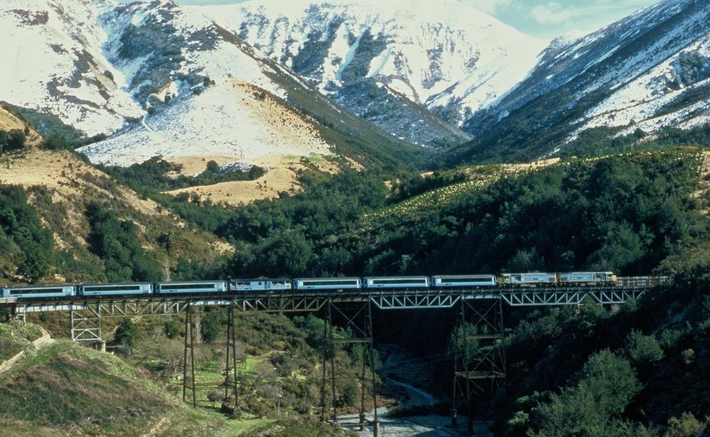 The TranzAlpine Express rattles over a viaduct with snow-capped peaks behind. The middle carriage is open-air for snapping the views.
The TranzAlpine Express rattles over a viaduct with snow-capped peaks behind. The middle carriage is open-air for snapping the views.