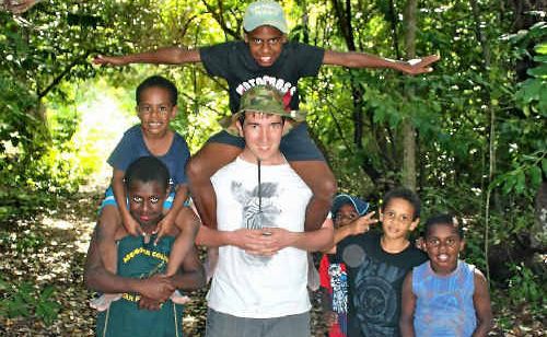 (Left) Mackay Christian College Year 11 student Daniel Fehring playing with local Torres Strait students on the island of Poruma. (Top right) A child models an outfit made by the MCC Year 9 Home Economics students. (Bottom right) MCC Year 11 students Josiah Westbrook and Rosie Fyvie enjoy games with some of the local children on Poruma. (Left) Mackay Christian College Year 11 student Daniel Fehring playing with local Torres Strait students on the island of Poruma. (Top right) A child models an outfit made by the MCC Year 9 Home Economics students. (Bottom right) MCC Year 11 students Josiah Westbrook and Rosie Fyvie enjoy games with some of the local children on Poruma.
