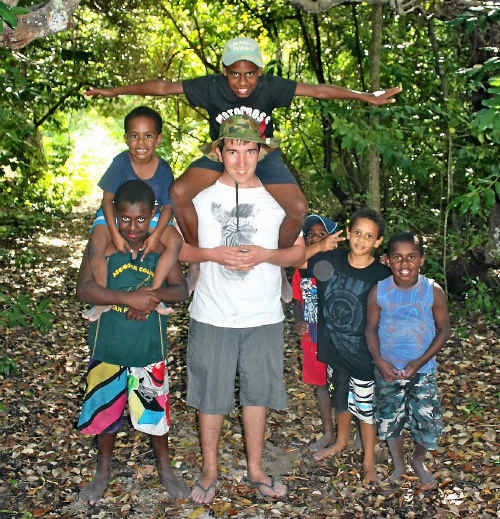 (Left) Mackay Christian College Year 11 student Daniel Fehring playing with local Torres Strait students on the island of Poruma. (Top right) A child models an outfit made by the MCC Year 9 Home Economics students. (Bottom right) MCC Year 11 students Josiah Westbrook and Rosie Fyvie enjoy games with some of the local children on Poruma. (Left) Mackay Christian College Year 11 student Daniel Fehring playing with local Torres Strait students on the island of Poruma. (Top right) A child models an outfit made by the MCC Year 9 Home Economics students. (Bottom right) MCC Year 11 students Josiah Westbrook and Rosie Fyvie enjoy games with some of the local children on Poruma.