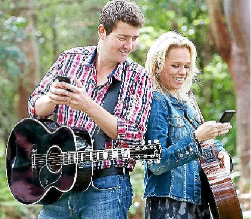 Muster stars Adam Harvey and Beccy Cole using the Gympie Muster’s new Optus Mobi-site. Muster stars Adam Harvey and Beccy Cole using the Gympie Muster’s new Optus Mobi-site.