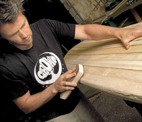 Grown Surfboards founder Andrew Wells with a new wooden surfboard creation. www.craigparry.com.au Grown Surfboards founder Andrew Wells with a new wooden surfboard creation. www.craigparry.com.au