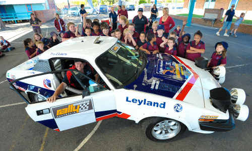 Troy and Penny O’Doherty show off their 1978 classic Triumph to kids at Coffs Harbour Primary School. Troy and Penny O’Doherty show off their 1978 classic Triumph to kids at Coffs Harbour Primary School.