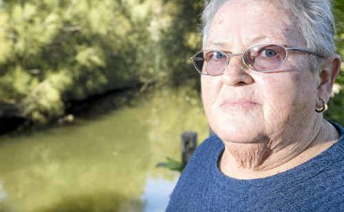 Pam Clarke of North Lakes Estate in Ballina is upset that Ballina Council refused to return to clean up rotting fish that died in a canal behind her home. Council removed the surface fish but are restricted from doing more by health and safety regulations. Pam Clarke of North Lakes Estate in Ballina is upset that Ballina Council refused to return to clean up rotting fish that died in a canal behind her home. Council removed the surface fish but are restricted from doing more by health and safety regulations.