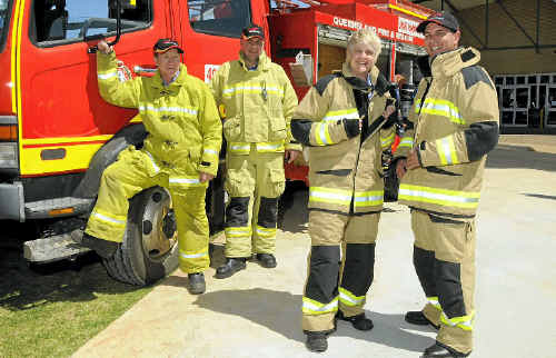Firefighters (from left) Shane Ott and Nathan Price, wearing the old generation firefighting ensembles, check out the new gear on Paula Douglas and Chris Sullivan.