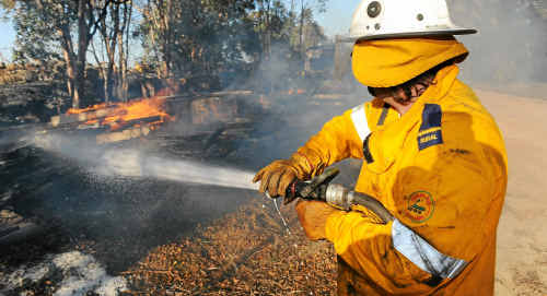 Bingera Weir Rural firefighter Darren Goodman-Jones keeps things under control as a small brush fire spreads through farm property. Bingera Weir Rural firefighter Darren Goodman-Jones keeps things under control as a small brush fire spreads through farm property.