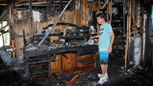 Adon Dinsmore looks through the remains of his Eimeo home after it was destroyed by a fire on Saturday night. He said although he has lost most of his possessions, he remains positive and is in good spirits. Adon Dinsmore looks through the remains of his Eimeo home after it was destroyed by a fire on Saturday night. He said although he has lost most of his possessions, he remains positive and is in good spirits.